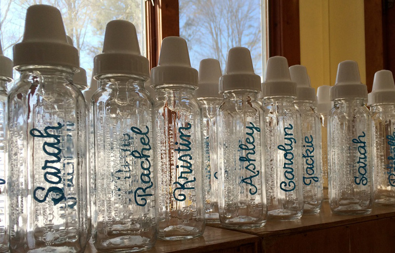 Baby shower fun. Guests sipped cocktails from these bottles. (With straws!)